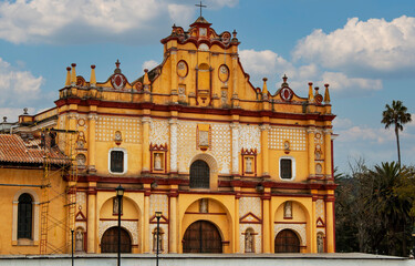 Exterior view of the historical Cathedral of San Cristóbal in the old town of  San Cristobal de las Casas, Chiapas, Mexico. Facade of a colonial yellow church. Traditional Mexican architecture. 