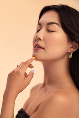 Asian female model touching chin