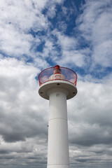 Crown, head of the lighthouse at the entrance to Howth Harbor in daylight with a beautiful blue sky, close up photo, background for graphics desighners, graphic background