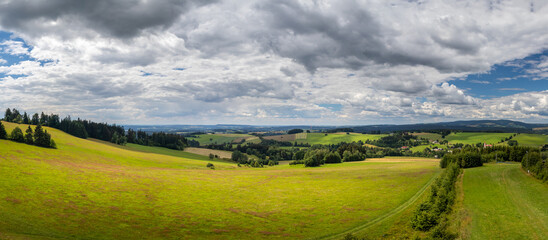Obraz premium countryside landscape with hill, field and forest, Orlicke mountains, Czech republic