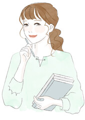 ペンと本をもって微笑む女性