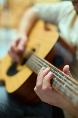Musician playing acoustic guitar classic music. Male guitarist perform melody. Musical lesson,...