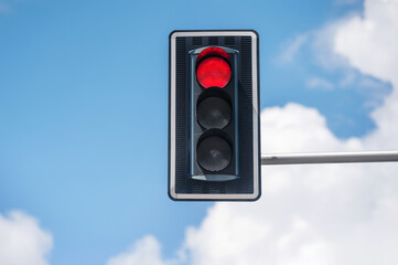 Traffic light against blue sky, space for text