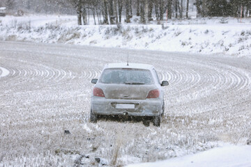 Wrecked Car in Stubble Field in Winter Snowfall, copy space for your text. 