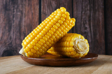 two pieces of sweet corn and seeds closeup