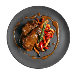 Plate of stewed lamb meat with vegetables and sauce