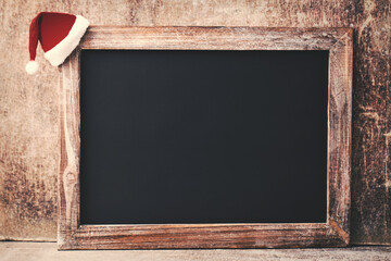 Christmas chalkboard and decoration over wooden background.