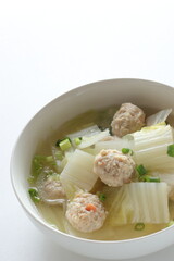Chicken meat ball and Chinese cabbage  soup in white bowl for winter hot pot food image