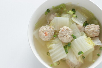 Chicken meat ball and Chinese cabbage  soup in white bowl for winter hot pot food image