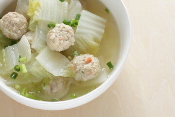 Chicken meat ball and Chinese cabbage  soup in white bowl for winter hot pot food image
