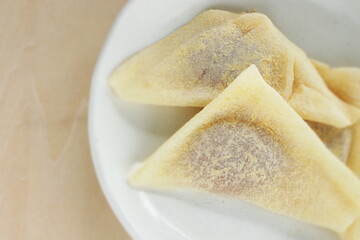 Japansese sweet food, Kyoto sweet potato paste in sticky rice in triangle shape for regional confectionery 