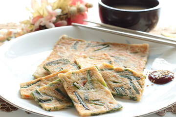 Korean food, leek pan cake with chili sauce and wine Makgeolli 