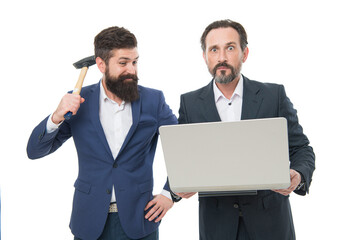 Virus detected. Businessmen hold computer infected with virus. Desperate men with hammer and...