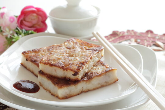 Chinese food, Pan fried radish cake on dish with sweet chili sauce for yum cha food image