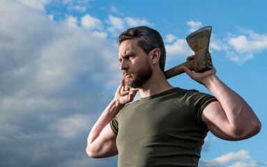 confident man with axe. caucasian man hold hatchet. brutal man on sky background