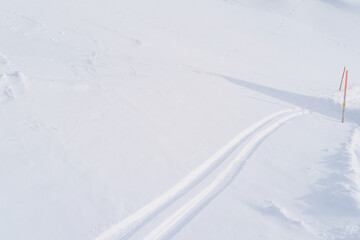 Obraz premium beautiful winter landscape, snowfall in the mountains, ski track, the path on the white snow, walks in the winter white forest, tourism, winter sports, Extreme Sports, Cross-Country Skiing