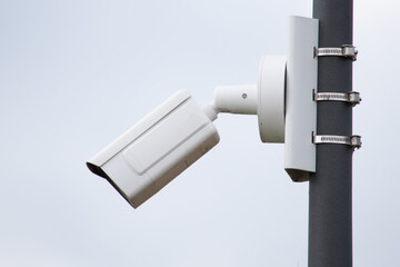 A surveillance camera on a pillar of a modern building.Video surveillance, Security.