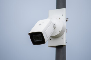 A surveillance camera on a pillar of a modern building.Video surveillance, Security.