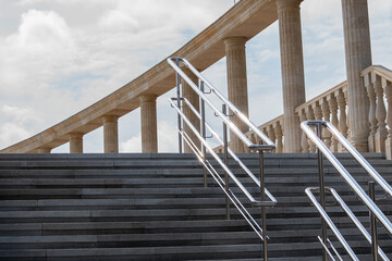 black metal railing against the background of brick steps of the amphitheater going down