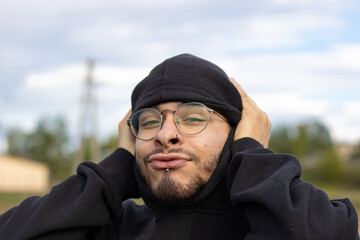 young man from front covering ears