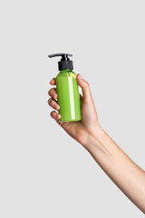 Woman hand showing cream product. Cosmetic product branding mockup. Daily skincare and body care routine. Female hand holding  cosmetic product mockup, close up.