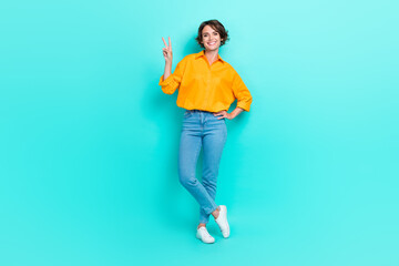 Fototapeta na wymiar Full length photo of pretty lady stand empty space show hi symbol her boyfriend dressed trendy outfit isolated on cyan color background