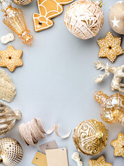 Christmas or New Year frame with gingerbread cookies, gift box tags, beige ribbon, golden baubles and decoration. Greeting card or invitation mockup with place for your text. Winter sale template.
