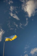 flag of Ukraine flying in the wind against the sky
