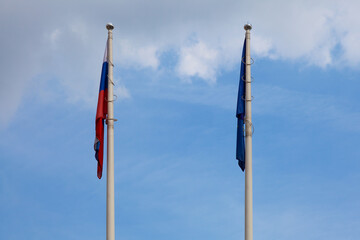 The flags of Russia and the European Union hang on flagpoles because of the lack of wind. May...