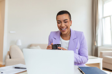 African-american elegant female entrepreneur discussing while having a conference call Portrait of confident ethnicity female employee looking at camera talking on video call in the home office.