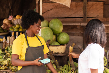 people in a local african market buying food items