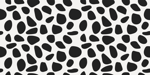 Black pebbles are scattered across the canvas. Vector from shapeless rounded shapes. For print and interior.