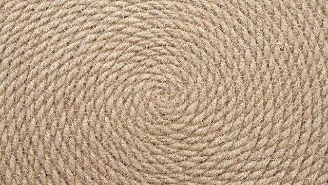 Jute braided spiral rug texture background clos-up.