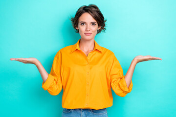 Portrait photo of young attractive pretty girl wear orange shirt hold palms balance choice isolated...