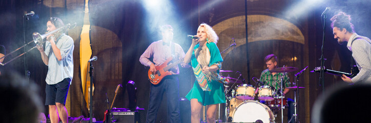 Rock band playing music on the concert stage at night