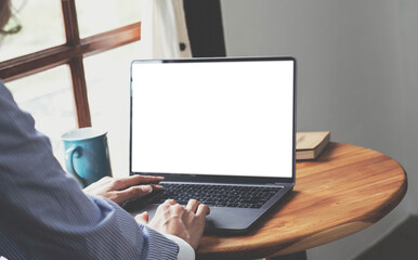 Fototapeta na wymiar Close-up, Business woman using portable laptop computer at her desk. Laptop blank screen mockup