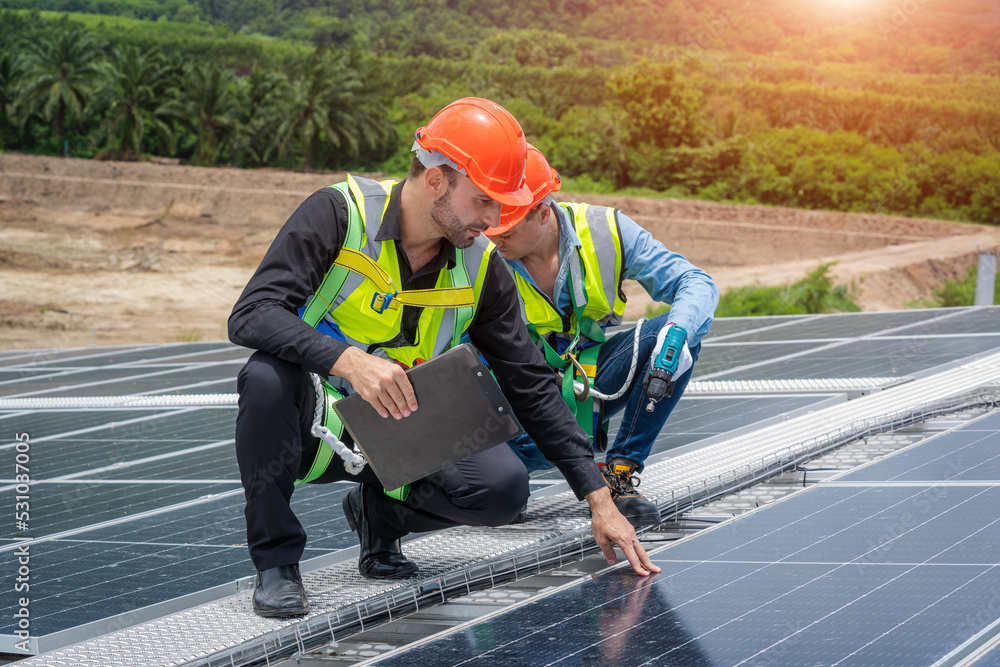 Poster engineer man or worker checking the operation of the system solar panels or solar cells on roof,rene