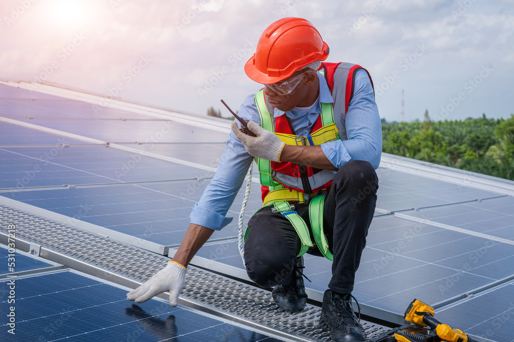 Poster engineer working and checking on solar panels on roof of factory,ecological,using natural renewable 