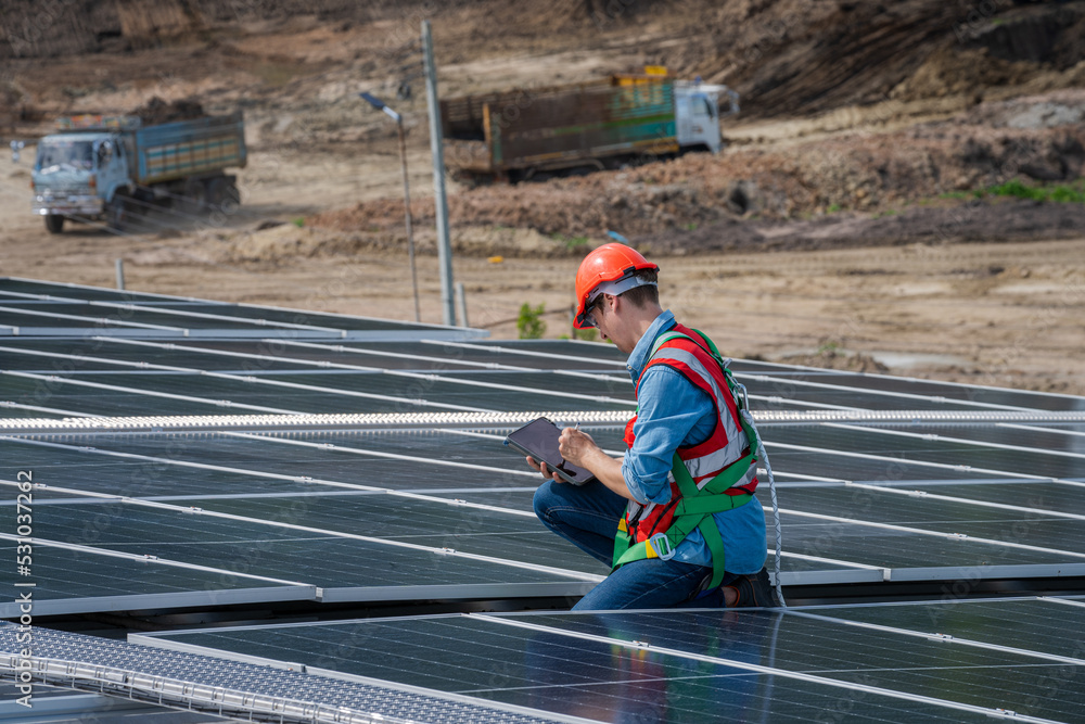 Poster engineers checking the operation of the system solar cell on roof at factory,alternative energy to c