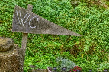 Wooden signboard with the words WC