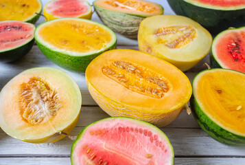 Variety of melons and water melons on wooden surface. Food backgrounds.