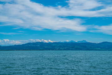 Germany, Bodensee lake water nature landscape panorama view to switzerland and alps mountains and saentis summit at sunset in summer