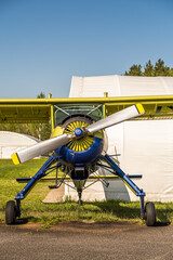 Parked small plane at a local airfield  - obrazy, fototapety, plakaty