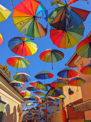 Fototapeta na wymiar The sky of colorful umbrellas. Street with umbrellas