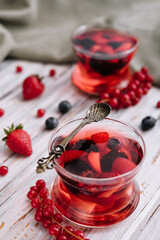Jelly with fresh berries on wooden table close up