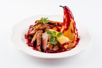 Fried duck fillet with pear on a plate