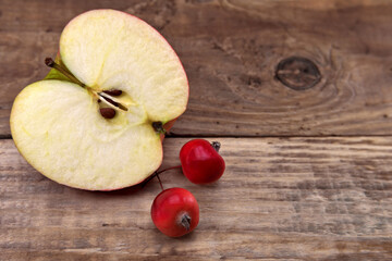 Whole apples and half on a wooden table