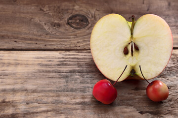 Whole apples and half on a wooden table