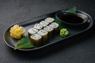 Kappamaki - cucumber sushi roll on black plate