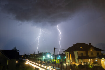 Bright lightnings over the city at the night.
